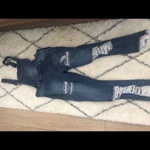 Distressed denim overalls.